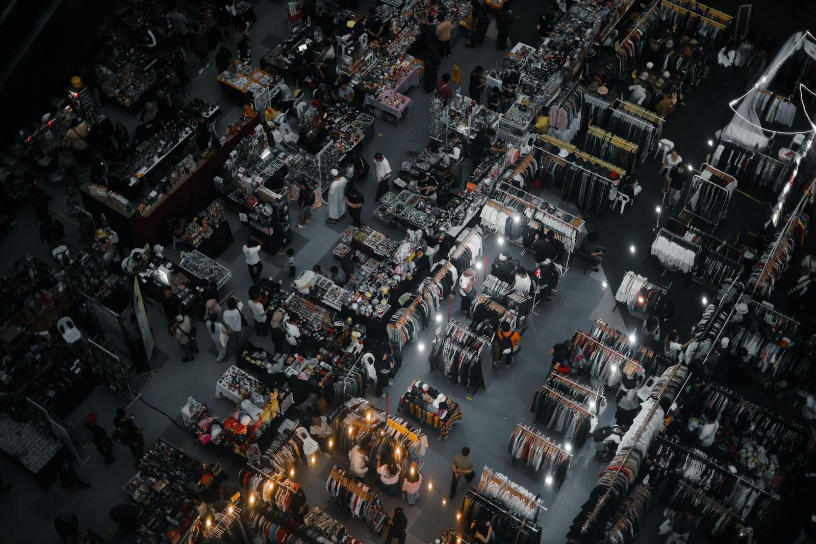 Dynamic aerial shot of a vibrant indoor market in Kuala Lumpur, Malaysia, showcasing diverse stalls and bustling activity.