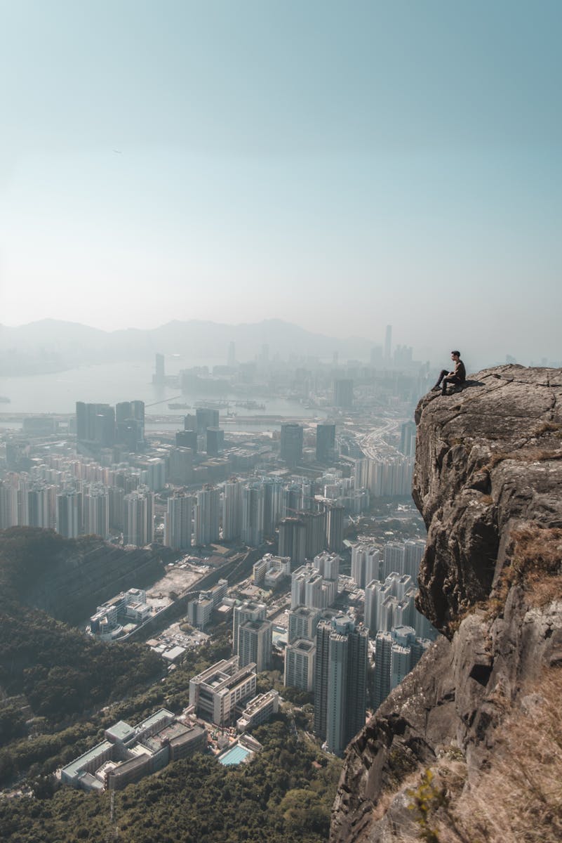 A breathtaking view from a cliff of Hong Kong's city skyline, capturing a sense of adventure.