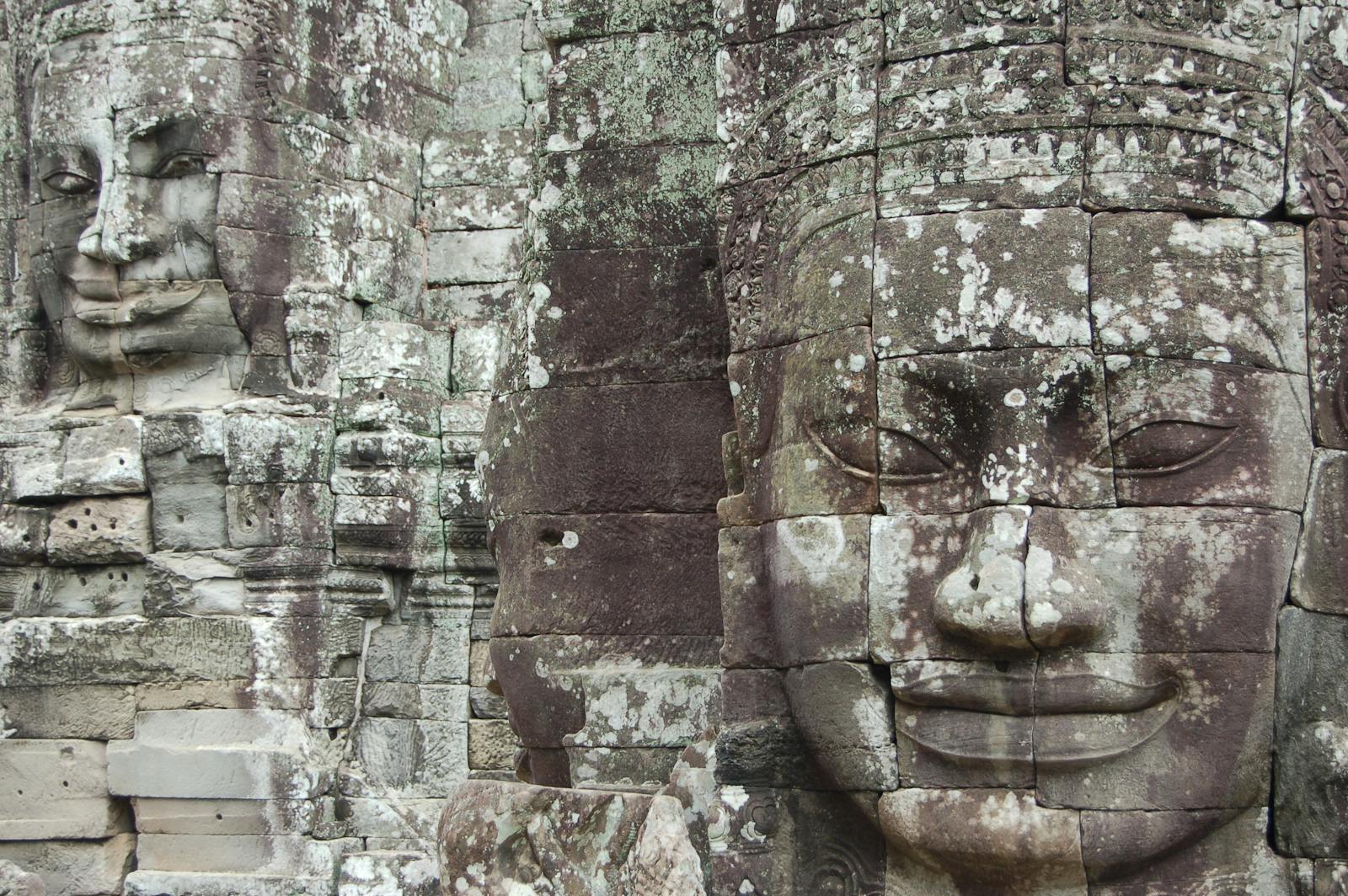 Explore detailed stone carvings of Bayon Temple faces in Angkor Wat, Cambodia.