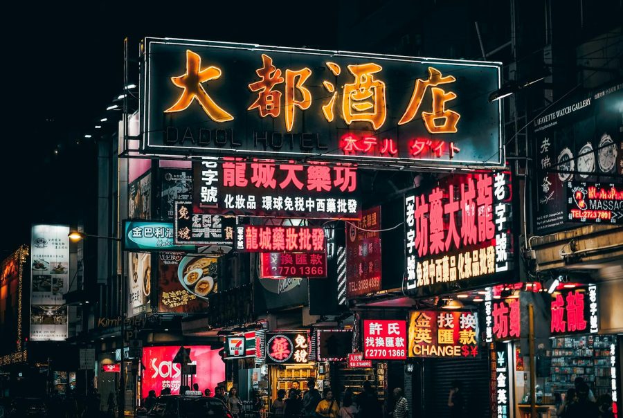 Colorful neon signs illuminate the bustling streets of Hong Kong, showcasing vibrant city nightlife.