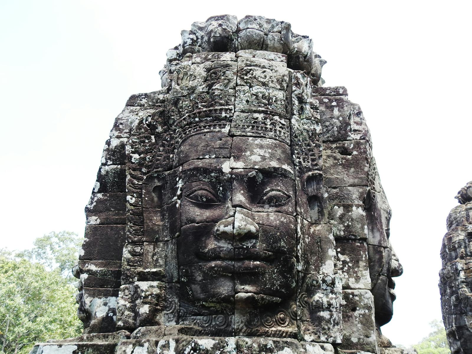 Stone carved faces of Bayon Temple, Siem Reap, Cambodia, reflecting ancient Khmer architecture.
