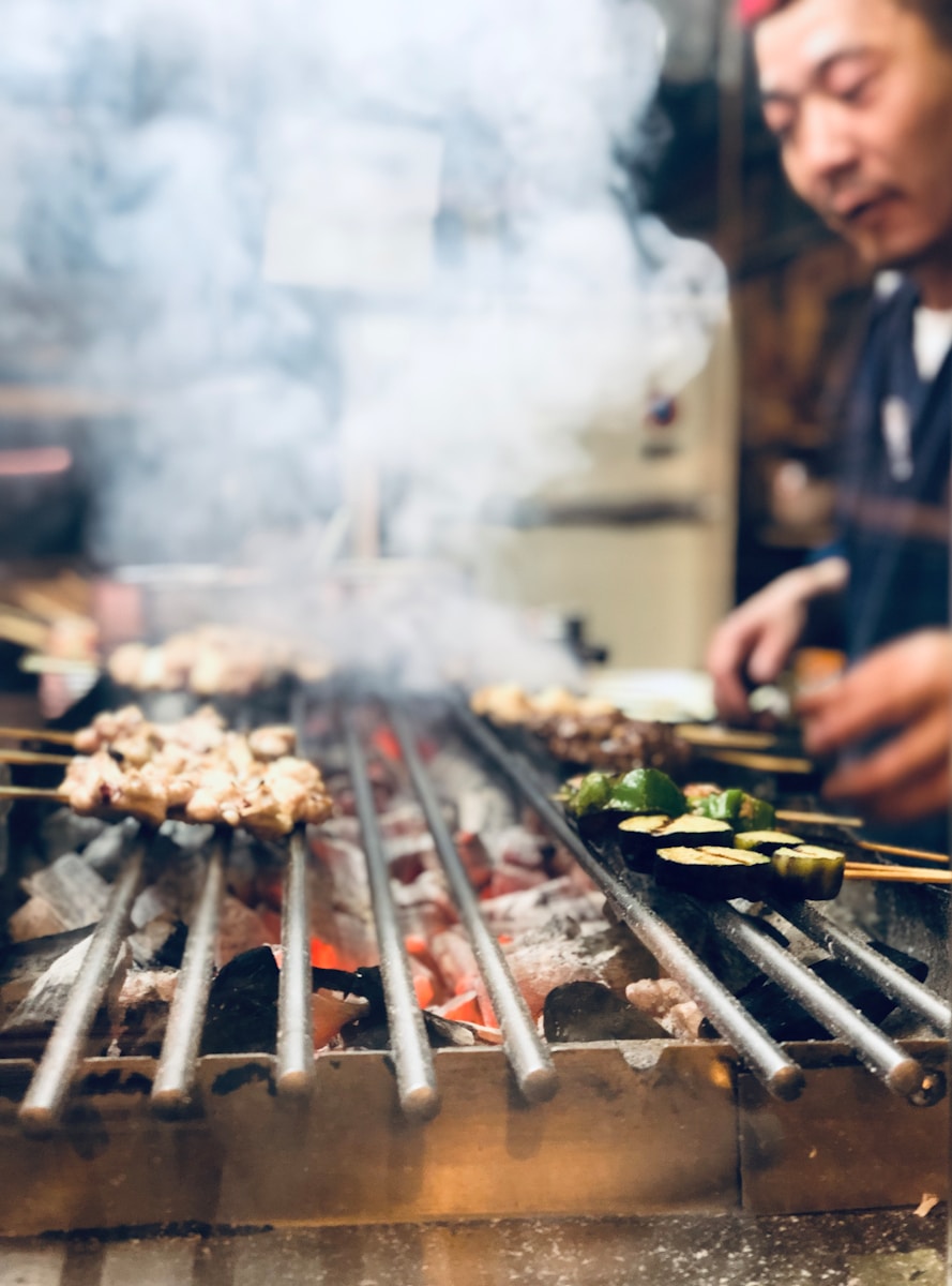 person grilling with charcoal