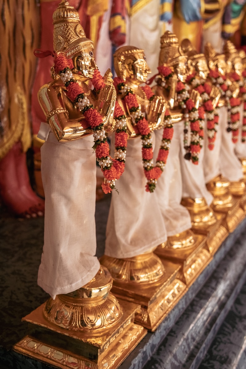 A row of gold statues sitting on top of a table