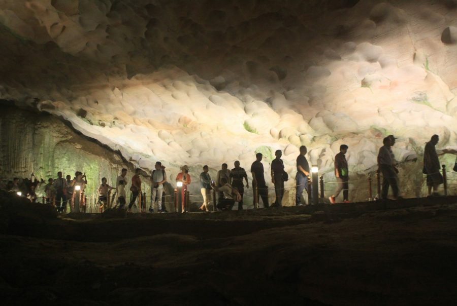 a group of people standing in a cave