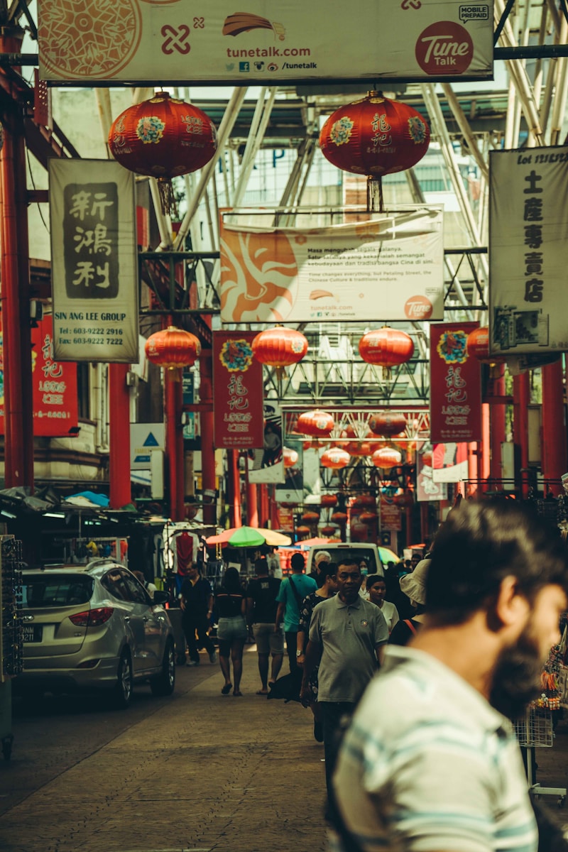 A crowded street in a festive asian market.