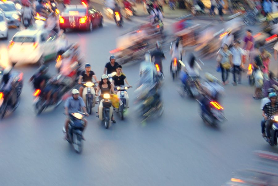 a blurry photo of a busy street filled with motorcycles