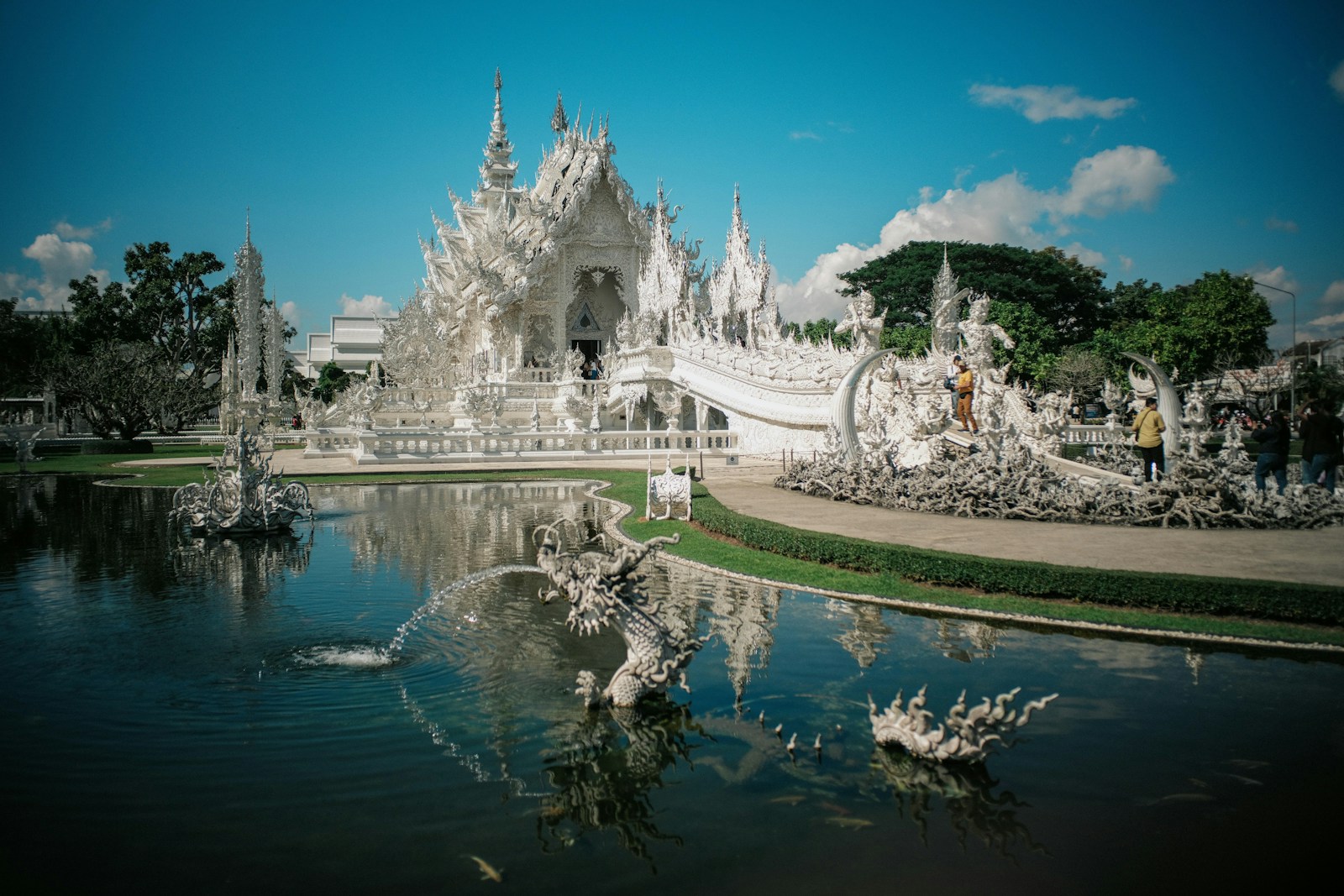 A large white building sitting next to a body of water